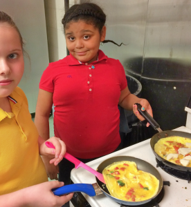 Students at Imagine Clay Avenue Community School prepare omelets at their Dinner of Excellence.